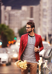 Image showing Man, street and walk with bouquet in city outdoor with style, fashion and outfit for date night. Confident, road and urban in elegant clothes or flowers with blazer in downtown for classy look