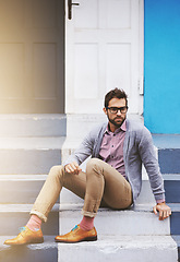 Image showing Man, building and serious on stairs for fashion, clothes and trendy with glasses outdoor in Cape Town, South Africa. Male person, gen z guy and vision for unique outfit, garment and urban style