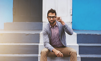 Image showing Man, glasses and portrait on stairs for fashion, clothes and trendy with eyewear outdoor in Cape Town, South Africa. Male person, gen z guy and lens flare for unique outfit, garment and urban style