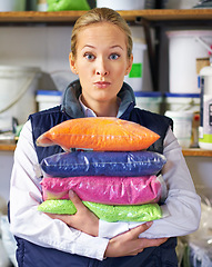 Image showing Woman, bag and plastic in factory, polymer and dye manufacturing and ecology in portrait in store. Person, industry and employee in recycling plant for storage, particles or warehouse for PVC pellets