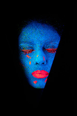 Image showing Face, neon and artistic paint for creative, art and glitter with unique surreal glow. Person, science fiction and color with dream, rave and abstract uv illusion for mystical fluorescent trance