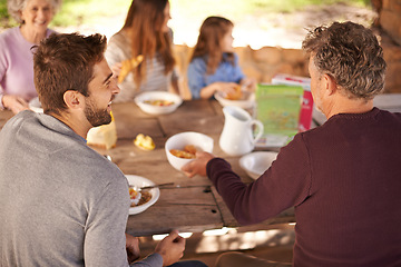 Image showing Outdoor, women and men with family for picnic in nature of backyard of house, smile and joy. Group of people and child eating breakfast on table of wood in summer, happiness and love together in home