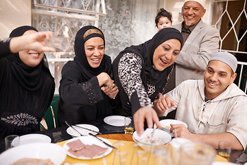 Image showing Muslim family, food and happy at lunch by table for eating, conversation and celebration on Eid. Islamic people, culture and special event with meal for nutrition, discussion and religious holiday