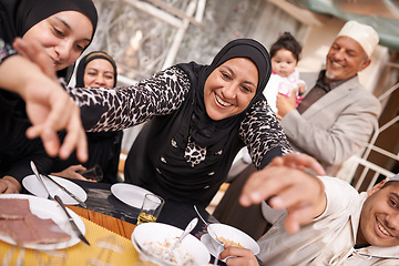 Image showing Muslim family, Eid and smile by table with food for celebration, conversation and eating together. Islamic people, culture and religious holiday with lunch for nutrition, discussion and special event