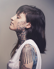 Image showing Tattoo, profile and woman with culture, rebel and confident person on a grey studio background. Face, girl and unique with edgy clothes and gothic design with heavy metal and artistic with tradition