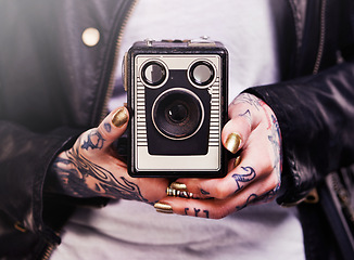 Image showing Person, hands and tattoo with camera for vintage, polish and creative for ink and design for picture and symbol. Art, bold and cool for capture and statement for photographer, trend and edgy