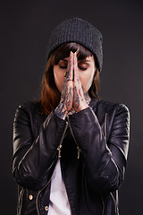 Image showing Praying, tattoo or woman in studio for fashion in leather jacket on black background for edgy style. Forgive, hope or cool female punk model with ink for unique art, aesthetic or creative expression