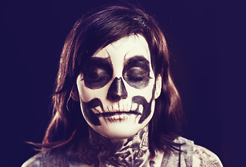 Image showing Skull, makeup and face of woman on black background for festival, Halloween and day of the dead. Creative art, skeleton costume and person with paint for horror, scary and gothic aesthetic in studio