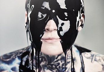 Image showing Paint, ink and face with black liquid for rock, tattoo and punk art in creative career isolated on gray background. Person, artist and closeup for surreal, unique and grunge on studio backdrop