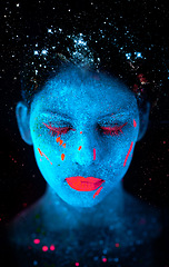 Image showing Face, neon and psychedelic paint for color, art and glitter with unique surreal glow. Person, science fiction and creative with dream, rave and abstract uv illusion for mystical fluorescent trance