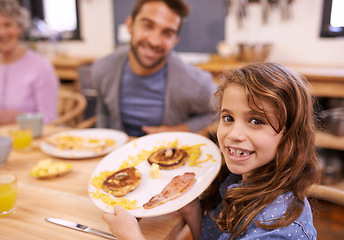 Image showing Portrait, child and breakfast in kitchen in home with family, eating and bonding together at table. Food, pancakes and father or grandmother with waffle for brunch nutrition or communication at house