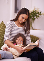 Image showing Woman, girl child or book on sofa as reading, imagine or fiction of happy bonding together in home. Mother, daughter or stories to relax on couch as listen or idea of fairy tale novel at weekend