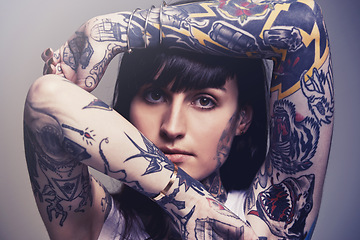 Image showing Tattoo, portrait and woman with culture, rebel and heavy metal on a grey studio background. Face, person and unique with edgy clothes and gothic design with confidence and artistic with tradition