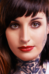 Image showing Portrait, tattoo and face of gothic woman in studio for edgy or rebel style in a closeup for red lipstick. Makeup, unique or cool punk model with ink on skin for art, fashion or creative expression