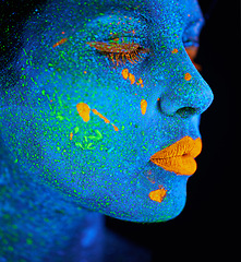 Image showing Woman, abstract and psychedelic paint for makeup with creativity, glow skin and fantasy beauty in studio. Girl, neon lips and cosmetics for portrait by black background, unique art and blue face