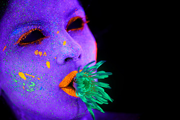 Image showing Neon, paint and face of woman with art in studio or plant for organic creativity, psychedelic aesthetic or mockup space. Glow makeup, person or fluorescent glitter for uv illusion on black background