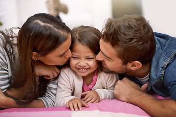 Image showing Kiss, parents or girl to love, lying or bed as happy, hug or memory of bonding together in house. Papa, mama or child as cheek, care or embrace in playful, parenting or childhood on joyful vacation