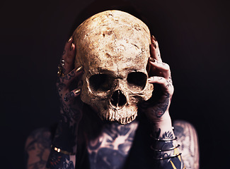 Image showing Skull, scary and woman with tattoo in studio for dark magic, horror or artistic aesthetic with mask. Creative nightmare, halloween culture or unique person with bones for demon on black background