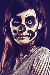 Image showing Skull, makeup and portrait of woman in studio for festival, Halloween and day of the dead. Creative art, costume and person with face paint for horror, scary and gothic aesthetic on black background