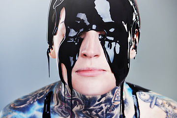 Image showing Abstract, paint and face with black ink for rock, tattoo and punk art in creative career isolated on gray background. Person, liquid and closeup for surreal, unique and grunge on studio backdrop