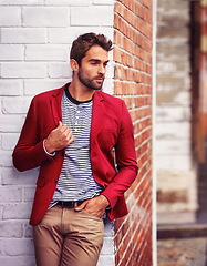 Image showing Man, think and fashion in urban wall or outdoor with outfit for casual or office wear for trends and style. Confident, street and city in elegant clothes with blazer in downtown for classy look