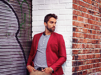 Image showing Man, think and clothes in urban wall or outdoor with outfit for casual or office wear for trends and style. Confident, street and city in elegant fashion with blazer in downtown for classy look
