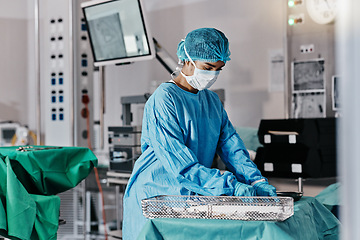 Image showing Doctor, table and emergency in theater for healthcare with mask, getting ready and surgery preparation in hospital. Surgeon, medical professional and safety in operating room for health and healing