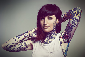 Image showing Portrait, tattoo or edgy woman in tank top on grey background for gothic style isolated in studio. Rockstar, unique or female punk model with ink on skin for body art, fashion or creative expression