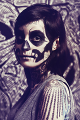 Image showing Skull, mask and portrait of woman on pattern for festival, Halloween and day of the dead. Creative makeup, costume and person with face paint for horror, scary and goth aesthetic in studio background