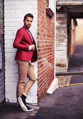 Image showing Man, confident and fashion in urban wall or outdoor with outfit for casual or office wear for trends and style. Thinking, street and city in elegant clothes with blazer in downtown for classy look