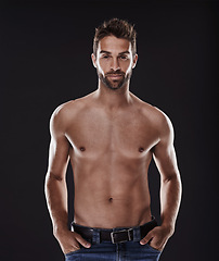 Image showing Portrait, abs and body of confident man in studio isolated on black background for wellness, fitness or exercise. Face, topless and muscle of person for health, serious or strong bodybuilder in Spain