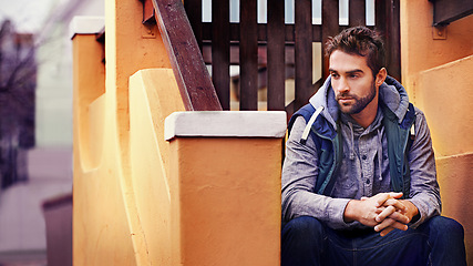 Image showing Fashion, relax or man on steps thinking of casual clothes, style or edgy hoodie for winter outdoor outfit. House, cool model or stylish male person in urban street on stairs in trendy jacket in Spain