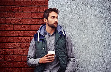 Image showing Fashion, wall or man with coffee thinking of casual clothes, style or edgy hoodie for winter outdoor outfit. Tea, cool model or stylish person in urban town in streetwear or trendy jacket in Italy