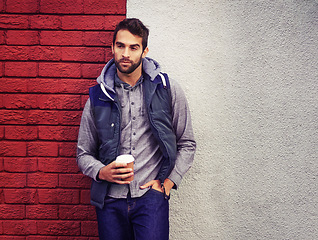 Image showing Fashion, wall or man with Coffee thinking of casual clothes, style or edgy hoodie for winter outdoor outfit. Tea, cool model or stylish person in urban town in streetwear or trendy jacket in Italy