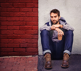 Image showing Fashion, wall or man on floor with coffee thinking of casual clothes, style or edgy hoodie for winter outfit. Tea, model or cool person in urban town in streetwear or trendy jacket in Italy to relax