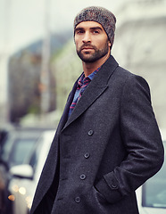 Image showing Fashion, portrait or man in city with coat for edgy clothes, outdoor travel or elegant style for winter outfit. Town, cool model or stylish guy in urban street in beanie or trendy jacket in Italy