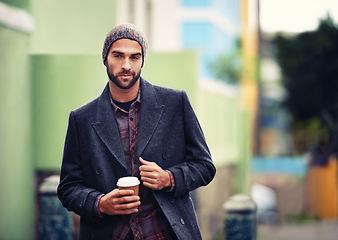 Image showing Fashion, portrait or man in street with coffee or coat for edgy clothes, outdoor travel or elegant style in winter outfit. City, drink or stylish guy in urban town in beanie or trendy jacket in Italy