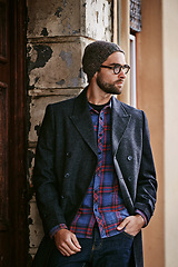 Image showing Fashion, outdoor or man by a wall thinking of casual clothes, style or edgy coat for a modern winter outfit. Travel, cool model or stylish person in an urban town in beanie or trendy jacket in Italy