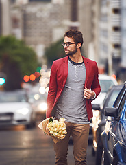 Image showing Fashion, flowers and urban for male person, city and street for walk or commute home. Autumn, trendy and contemporary style for man traveler in New York roads, cars and outdoor with roses bouquet