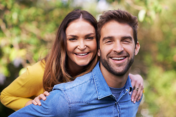 Image showing Portrait, nature and happy couple with piggyback in park for bonding, dating and relationship outdoor. People, love and romantic in backyard with smile or joy, excited and commitment in marriage