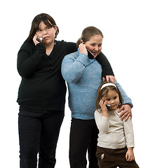 Image showing Three Girls Talking On Cell Phones