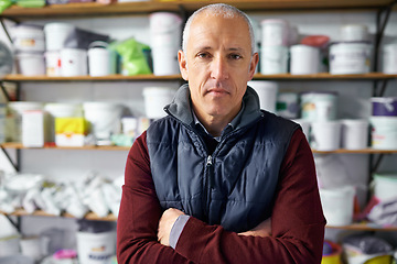 Image showing Portrait, man and confidence of store owner in business or retail for plastic in startup. Face, arms crossed or mature professional in shop, entrepreneur or manager with serious person in Switzerland