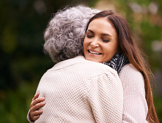 Image showing Hug, mother and woman outdoor with love, embrace and affection for bonding with happiness. Family, elderly female person and daughter with mom in garden, backyard and terrace with smile in nature