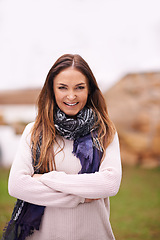 Image showing Fashion, portrait and woman with arms crossed outdoor in backyard or garden of home in winter. Girl, smile and confidence on holiday or vacation with casual style, happiness and relax with pride