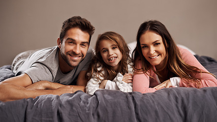 Image showing Parents, girl and portrait in bedroom to relax in home for weekend break, family time and happiness for bonding. Father, mother and child comfy or cozy together on Easter Sunday morning for love.