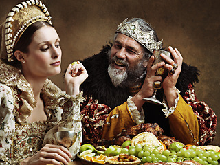 Image showing King, queen and royalty with feast and wine in banquet hall for fine dinning for tradition or culture in palace. Monarch, sovereign and together with buffet for luxury, bored and vintage with goblet.