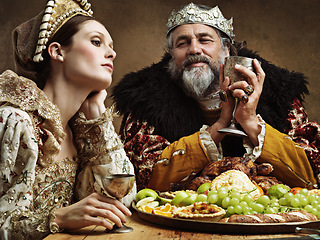 Image showing King, queen and feast with wine at table for fine dinning in royal banquet, vintage and majestic with crown. Monarch, husband and bored together with alcohol and buffet for formal celebration