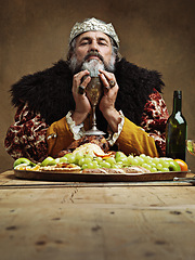 Image showing King, feast and wine glass in table as royalty on dining hall for tradition, culture and meal in palace. Portrait, monarch and food with eating buffet or supper in confidence as majesty and crown