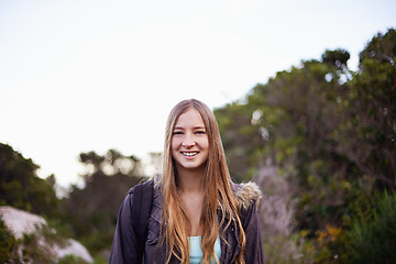 Image showing Outdoor, nature and portrait of girl with smile for hiking with backpack for journey in foliage or bush. Adult, female person and woman with happiness for travel for winter holiday in Cape Town