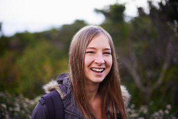 Image showing Outdoor, nature and portrait of girl with backpack for hiking with smile for journey in foliage or bush. Adult, female person and woman with happiness for travel for winter holiday in Cape Town